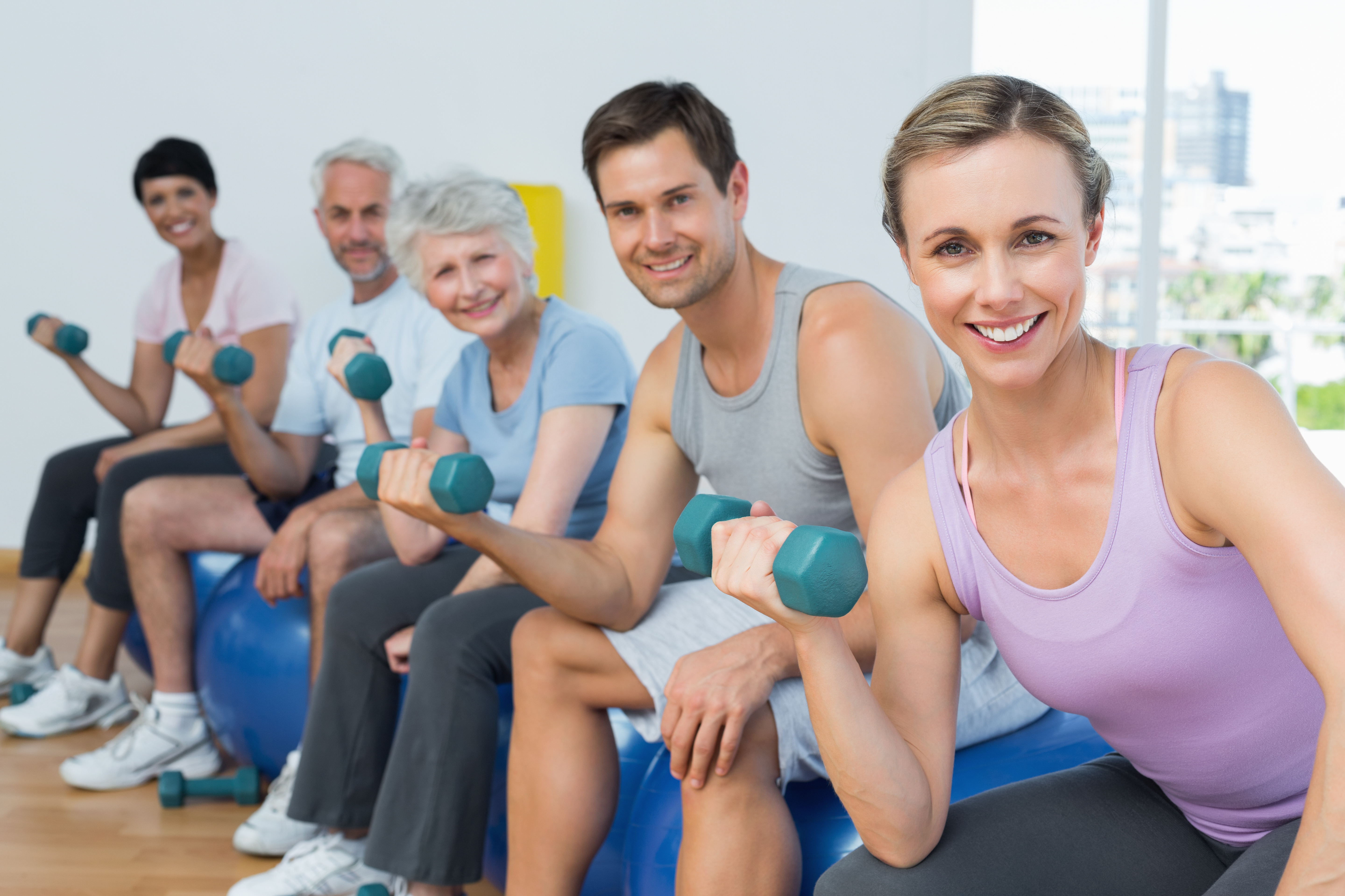 all ages of people lifting hand weights